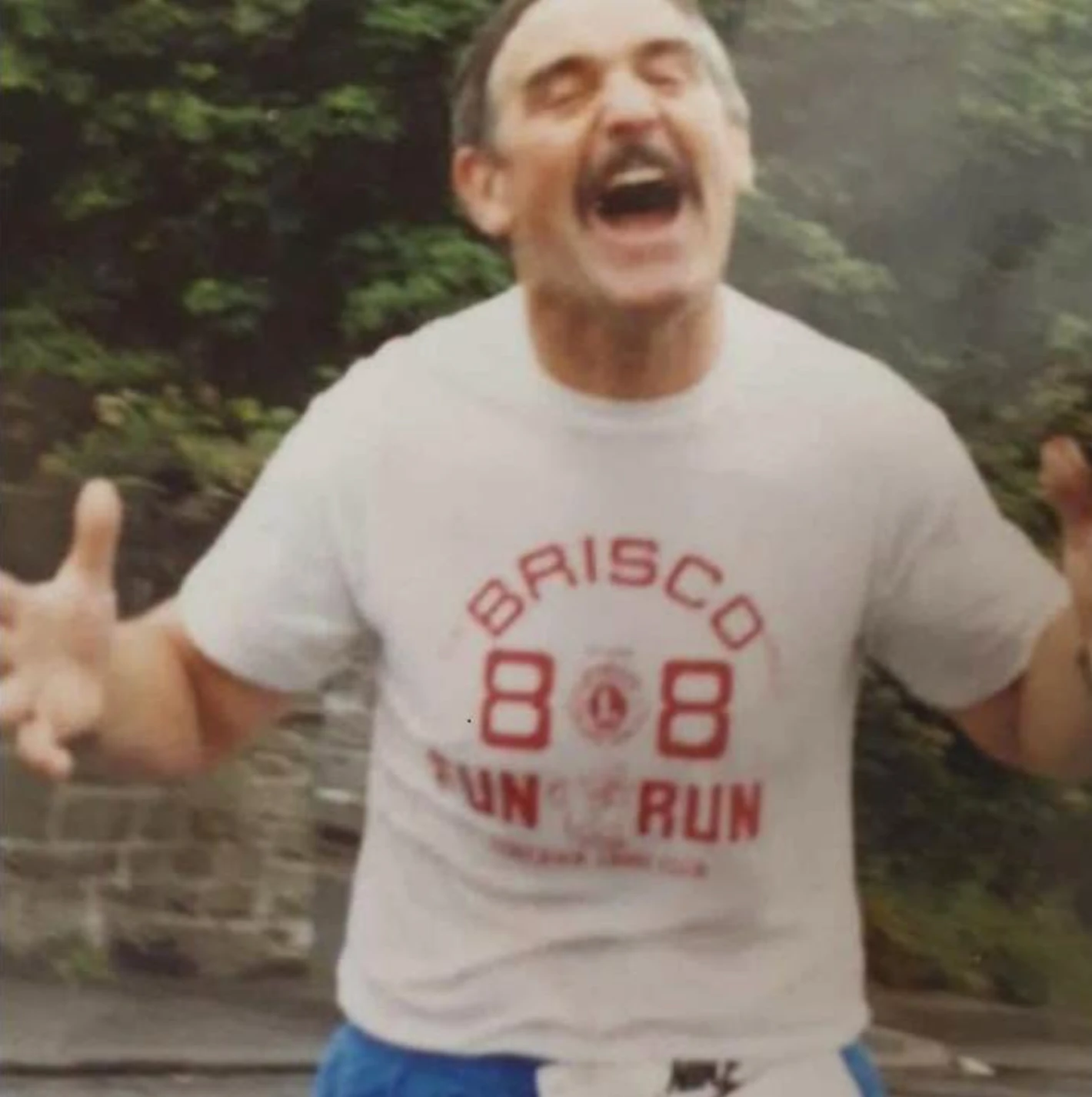 A smiling runner wearing a historic BRISCO Gorseinon Fun Run shirt
