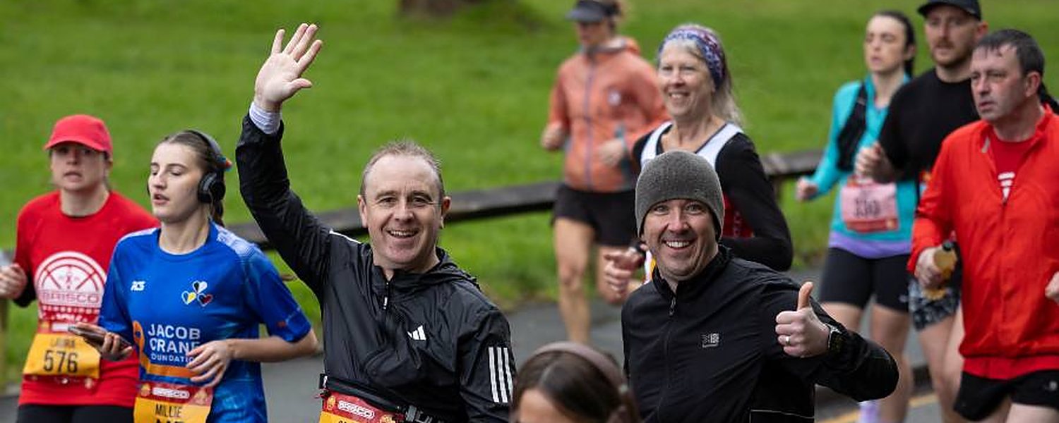 Runners waving on the closed roads at the BRISCO Gorseinon 10K